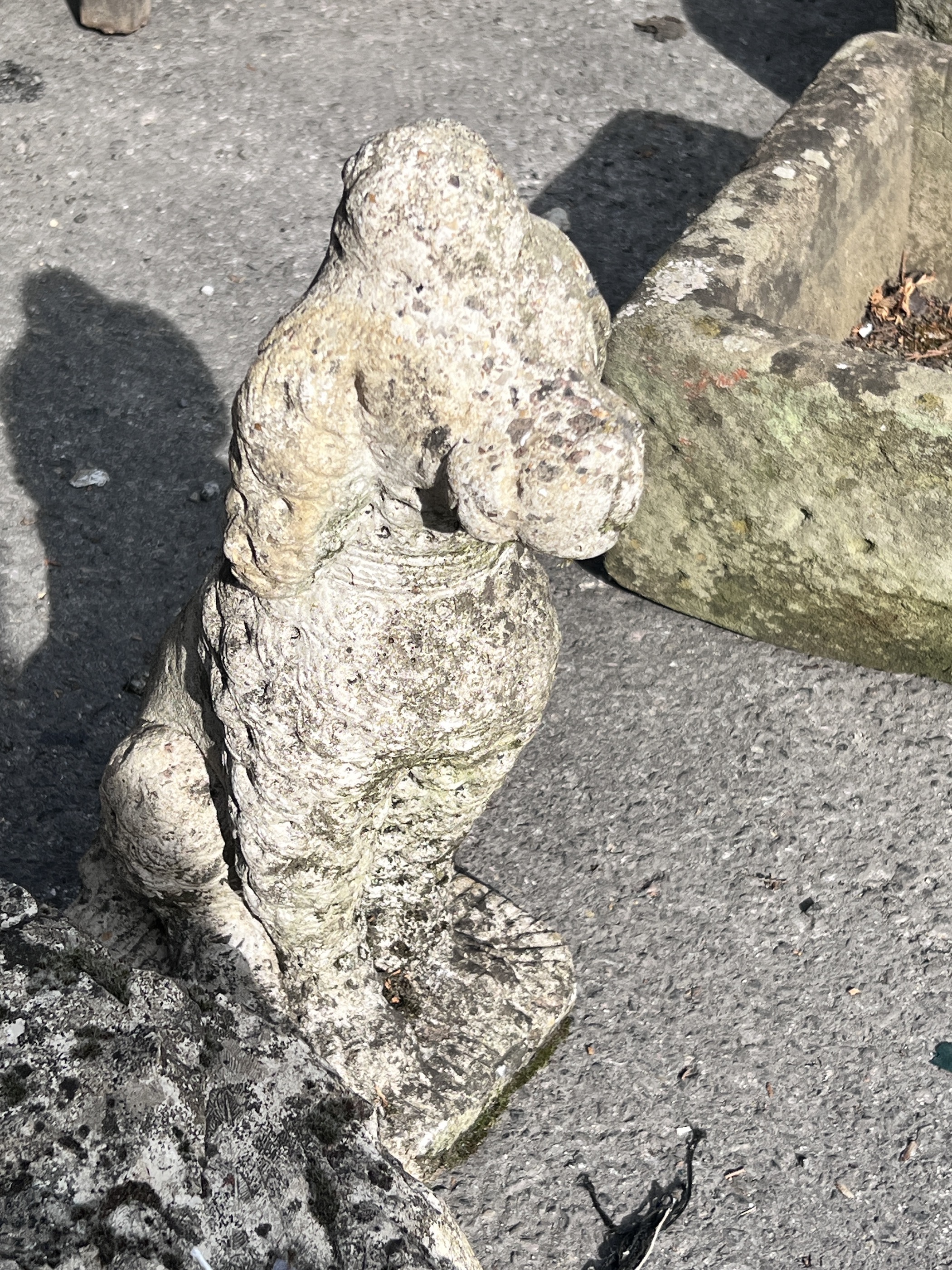 A stone fragment and a reconstituted stone figure of a dog, height 44cm